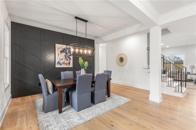 dining space featuring light hardwood / wood-style floors and a notable chandelier