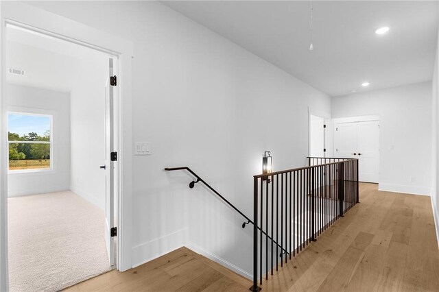 stairway with hardwood / wood-style floors