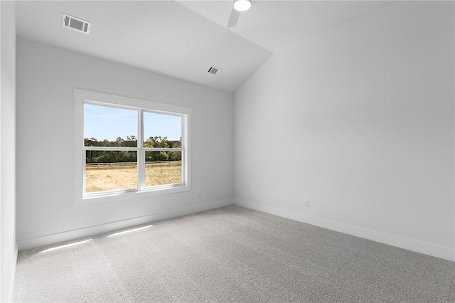 carpeted spare room with ceiling fan and lofted ceiling