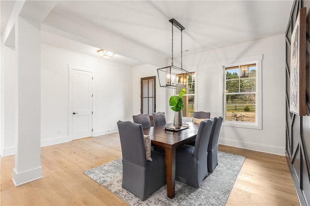 dining area featuring light hardwood / wood-style floors and a chandelier