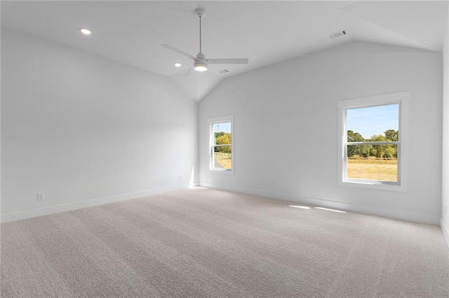 spare room with ceiling fan, carpet floors, and vaulted ceiling