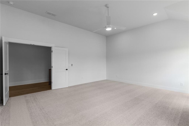 empty room with ceiling fan, light carpet, and lofted ceiling