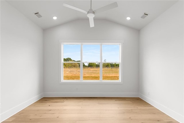 empty room featuring ceiling fan, lofted ceiling, and light hardwood / wood-style flooring