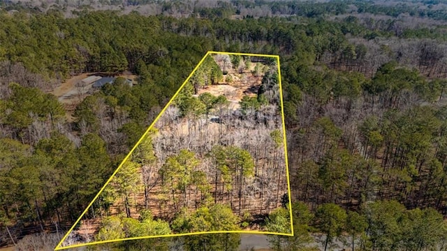 birds eye view of property featuring a view of trees