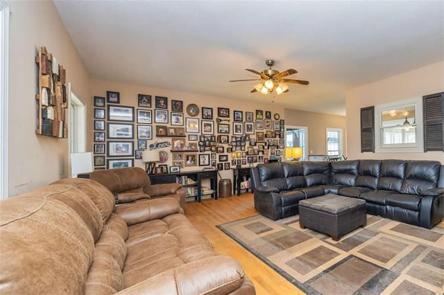 living area with ceiling fan and wood finished floors