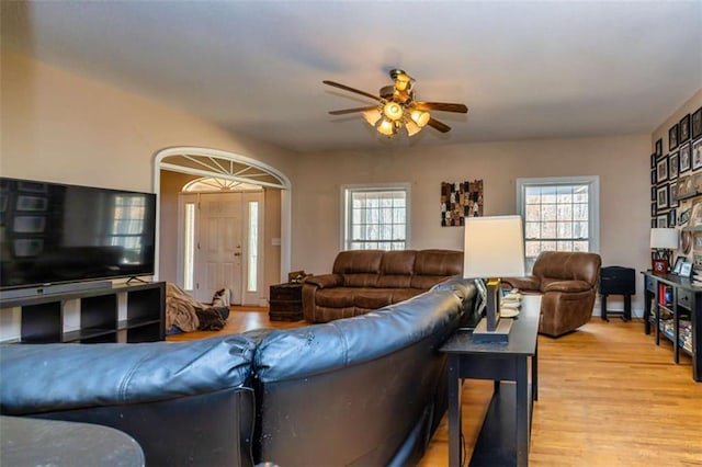 living area featuring a healthy amount of sunlight, ceiling fan, and wood finished floors