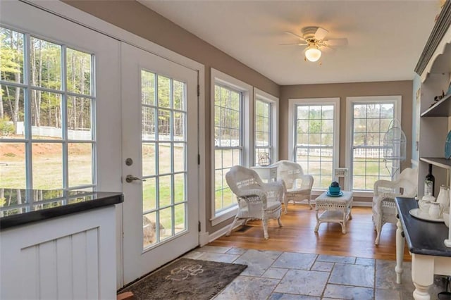 sunroom featuring ceiling fan