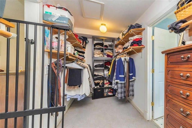 walk in closet featuring attic access