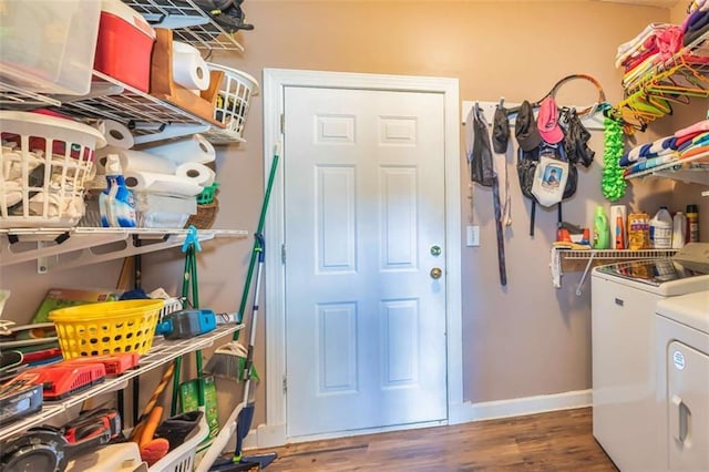 laundry area featuring laundry area, baseboards, dark wood finished floors, and washer and dryer