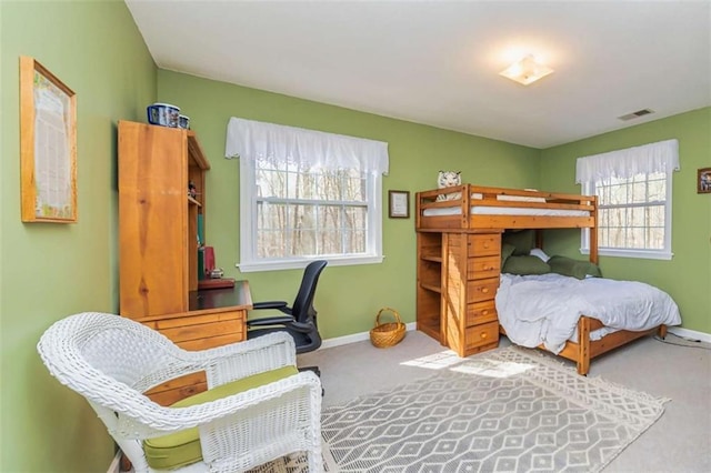 carpeted bedroom with visible vents and baseboards