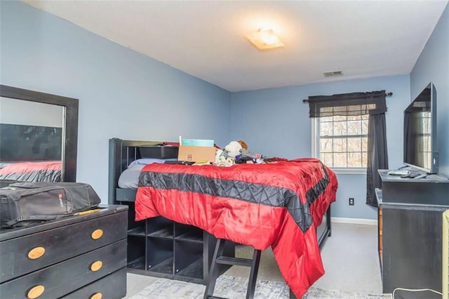 bedroom with baseboards and visible vents