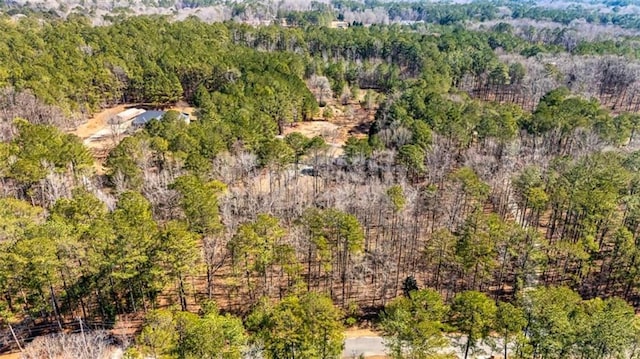 birds eye view of property featuring a wooded view