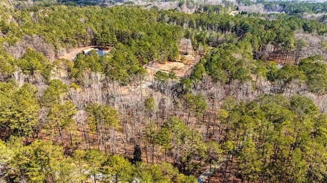 drone / aerial view featuring a wooded view