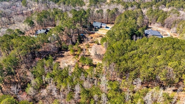 birds eye view of property featuring a wooded view