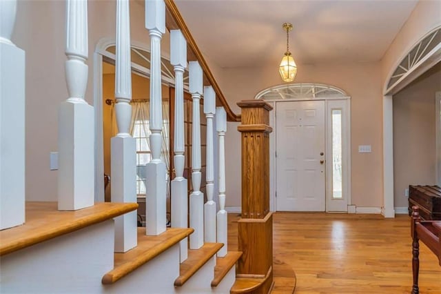 foyer featuring light wood-style floors and stairs