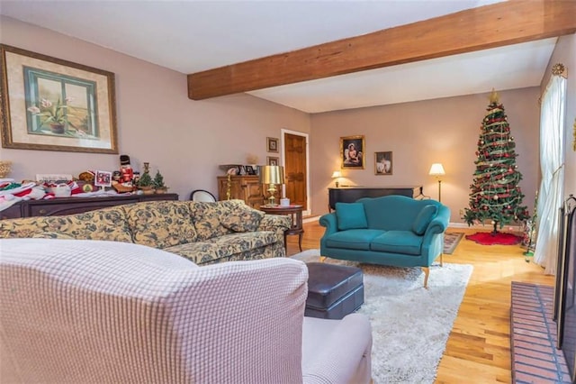 living area featuring wood finished floors and beamed ceiling