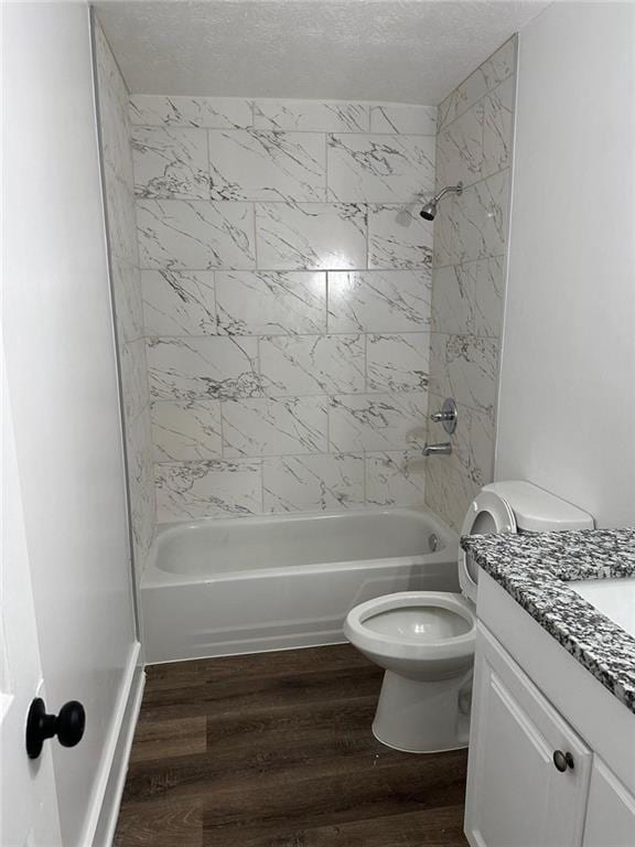 full bath featuring shower / bathtub combination, a textured ceiling, wood finished floors, and vanity