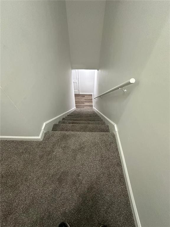 staircase with carpet floors and baseboards