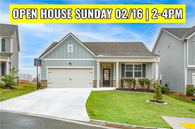 craftsman inspired home featuring a garage, a front yard, and covered porch