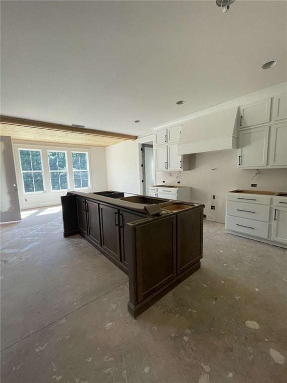 1210 Askew Trl, Greensboro, GA 30642 - kitchen with unfinished concrete floors, white cabinets, and dark brown cabinetry