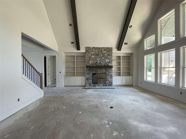 1210 Askew Trl, Greensboro, GA 30642 - unfurnished living room with stairs, high vaulted ceiling, built in shelves, a fireplace, and beamed ceiling