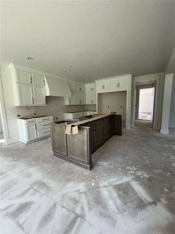 1210 Askew Trl, Greensboro, GA 30642 - kitchen featuring white cabinetry, a center island, and custom exhaust hood