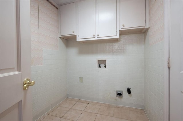 laundry area featuring washer hookup, hookup for an electric dryer, and light tile patterned floors