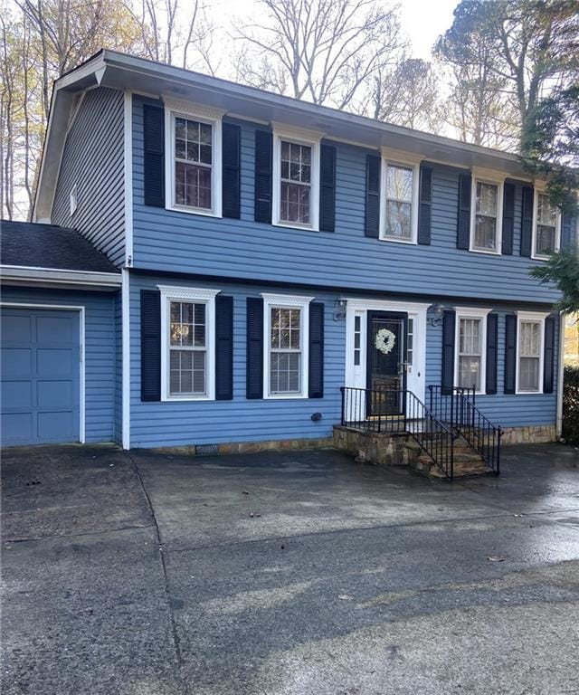 colonial-style house featuring a garage