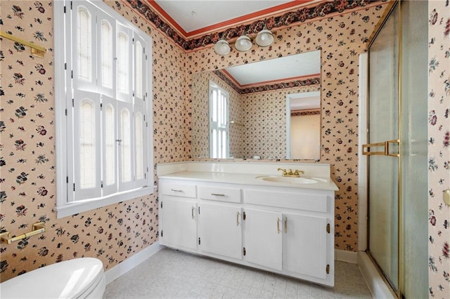 bathroom featuring vanity, toilet, and a shower with shower door