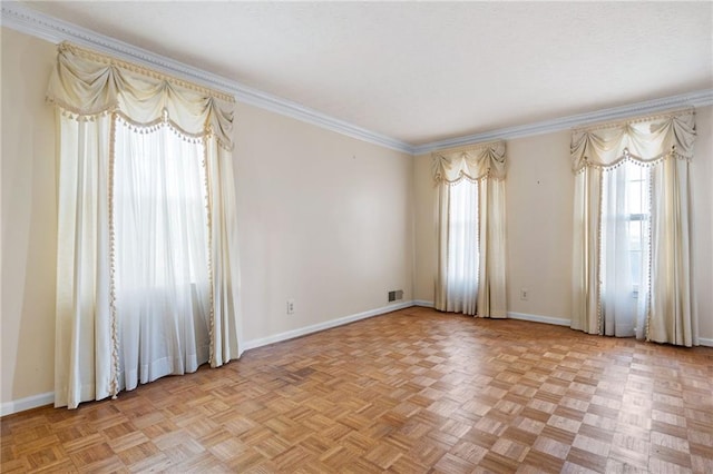 empty room with crown molding and light parquet flooring