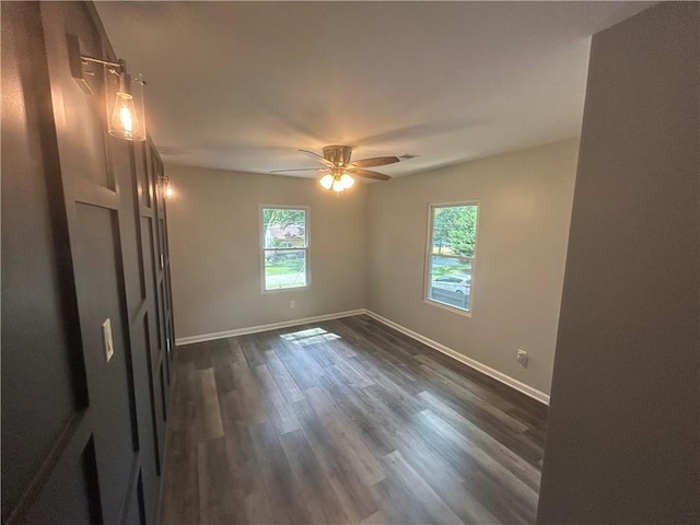5090 Lorraine Pl, Forest Park, GA 30297 - spare room featuring plenty of natural light, baseboards, dark wood finished floors, and a ceiling fan
