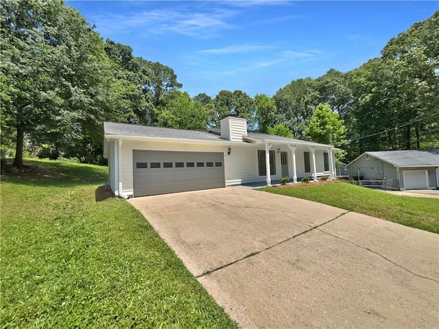2492 Wild Rose Cir, Lawrenceville, GA 30044 - single story home with a front yard, a chimney, an attached garage, and driveway