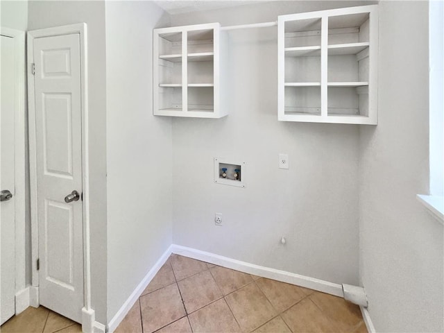 2492 Wild Rose Cir, Lawrenceville, GA 30044 - laundry area featuring electric dryer hookup, hookup for a washing machine, light tile patterned flooring, and baseboards
