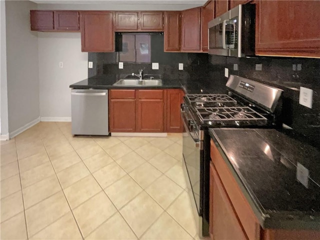 2492 Wild Rose Cir, Lawrenceville, GA 30044 - kitchen with appliances with stainless steel finishes, a sink, tasteful backsplash, baseboards, and brown cabinetry