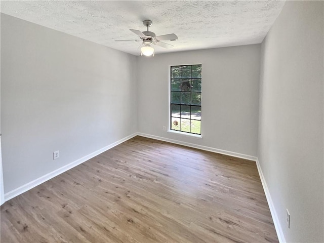 2492 Wild Rose Cir, Lawrenceville, GA 30044 - unfurnished room featuring wood finished floors, a textured ceiling, ceiling fan, and baseboards