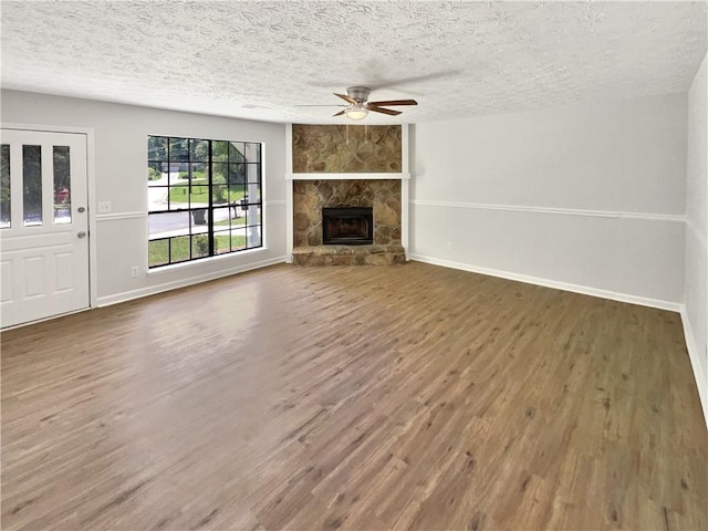 2492 Wild Rose Cir, Lawrenceville, GA 30044 - unfurnished living room with a ceiling fan, wood finished floors, baseboards, and a textured ceiling