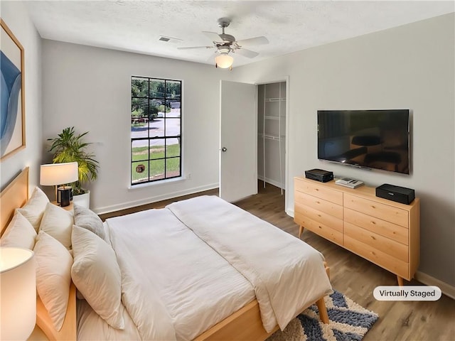 2492 Wild Rose Cir, Lawrenceville, GA 30044 - bedroom with wood finished floors, baseboards, and ceiling fan