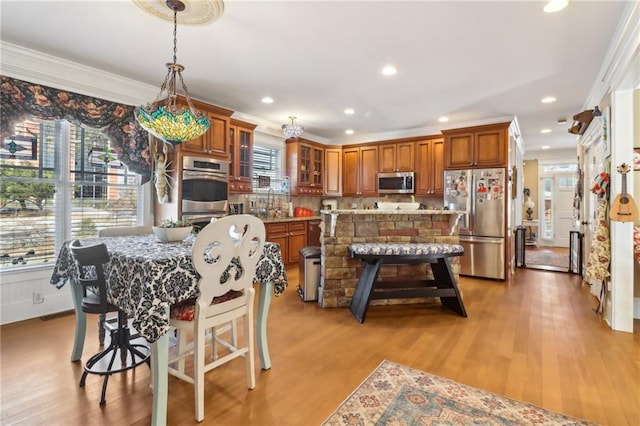 dining space with a wealth of natural light and light hardwood / wood-style flooring