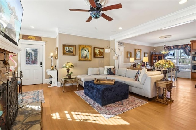 living room with crown molding, ceiling fan, and wood-type flooring