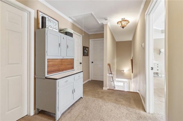 hall featuring crown molding and light colored carpet