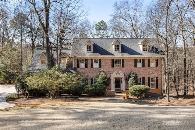 colonial house featuring brick siding