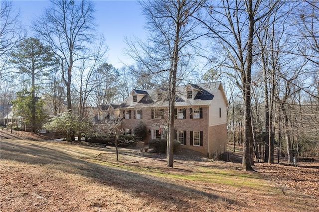 colonial home featuring brick siding