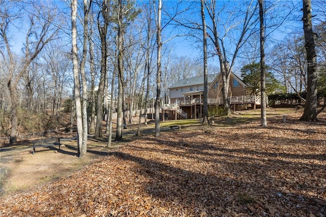 view of yard with stairs and a deck