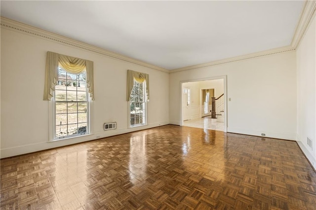 spare room featuring visible vents, stairs, baseboards, and crown molding