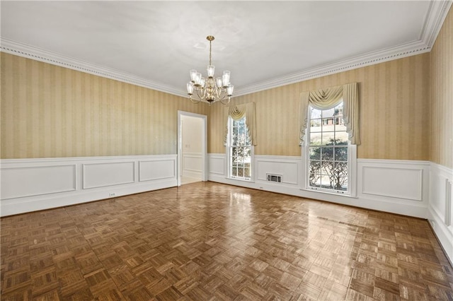 empty room with wallpapered walls, wainscoting, visible vents, and an inviting chandelier