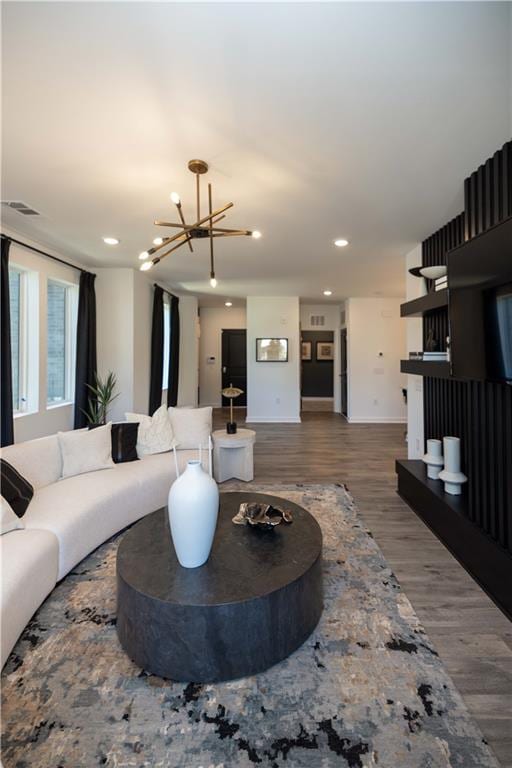 living room with wood-type flooring and a chandelier