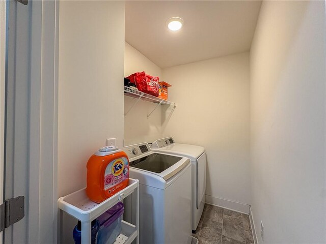 114 Garrison Dr, Winder, GA 30680 - laundry room with washer and dryer and stone finish flooring