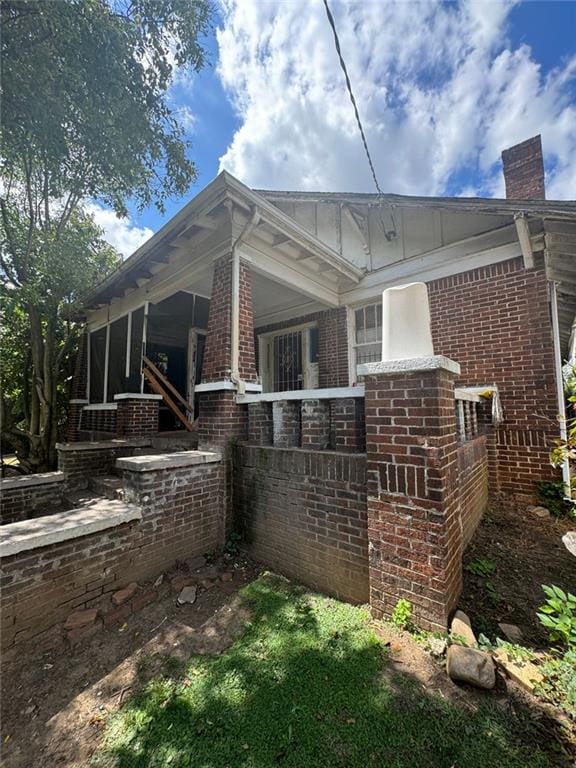 view of side of property with a porch