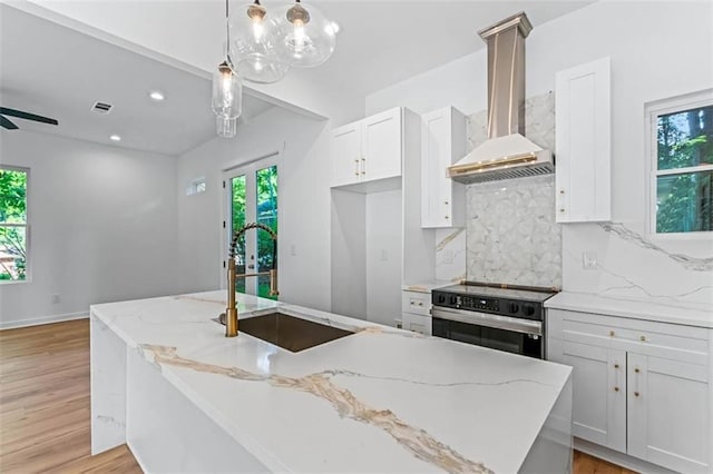 1835 Taylor Ave, East Point, GA 30344 - kitchen with wall chimney exhaust hood, stainless steel electric stove, healthy amount of natural light, decorative backsplash, and recessed lighting