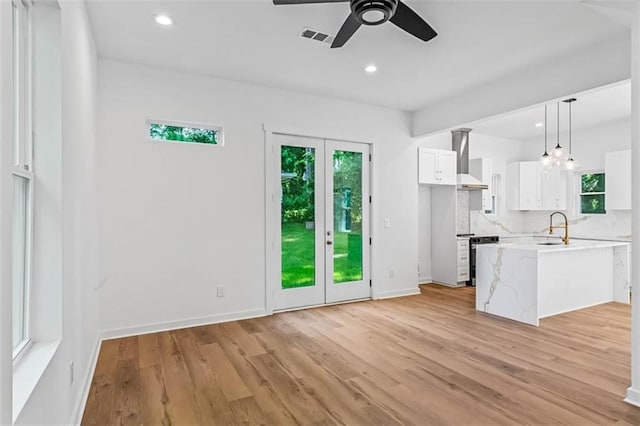 1835 Taylor Ave, East Point, GA 30344 - kitchen with healthy amount of natural light, a ceiling fan, light wood-type flooring, white cabinets, and recessed lighting